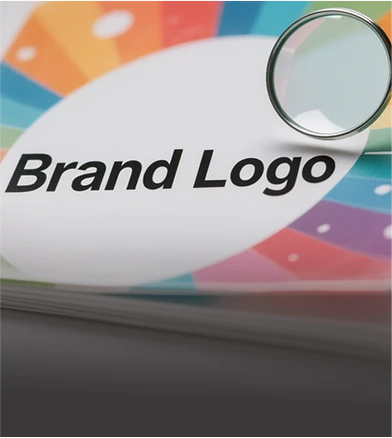 Magnifying glass inspecting brand logo print quality and surface finishing