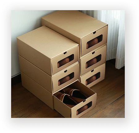 Stacked kraft shoe boxes with clear window drawers under retail stacking loads