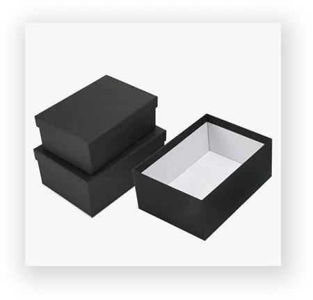 Black rigid two-piece set-up boxes, one closed and one open, a core structure for apparel and footwear packaging